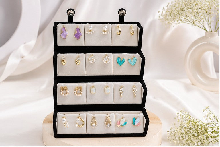 dazzle21 12-pair earring set featuring gold-tone, pearl, and colorful enamel designs in a black velvet display box.