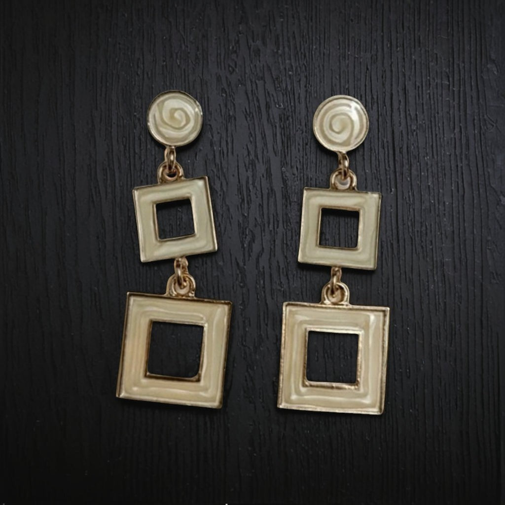 dazzle21 cream geometric square drop earrings with a modern double-square design on a dark textured background