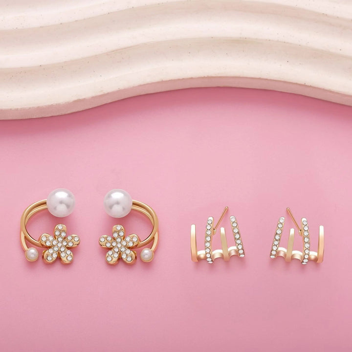 dazzle21 gold-tone daisy flower earrings with faux pearls and crystal studs on a pink background