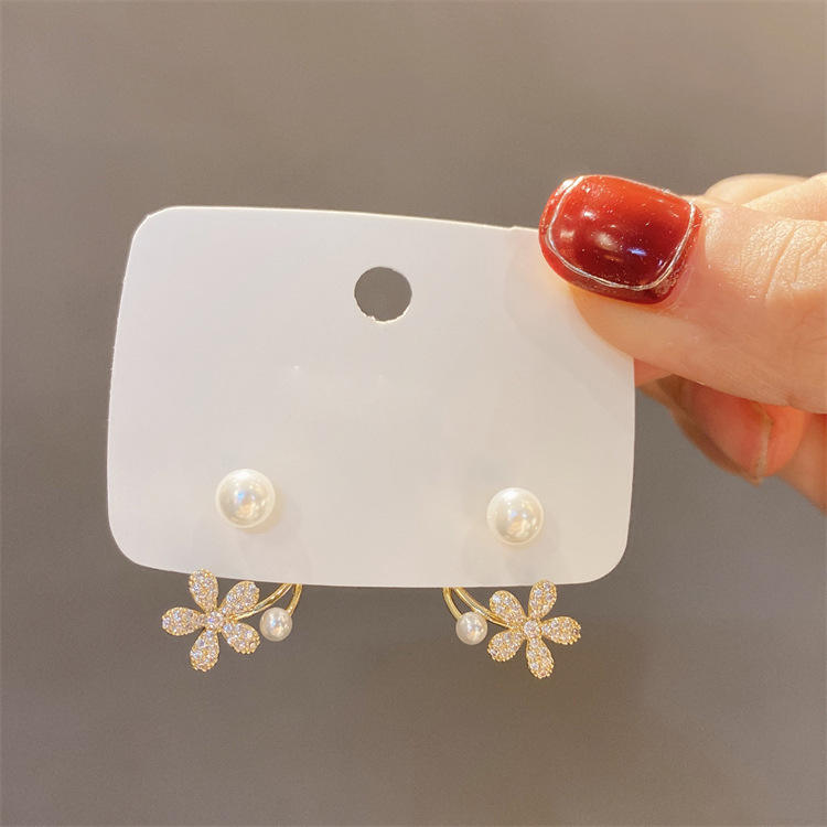 dazzle21 gold-tone daisy ear jacket earrings with micro-crystals and faux pearls on a display card