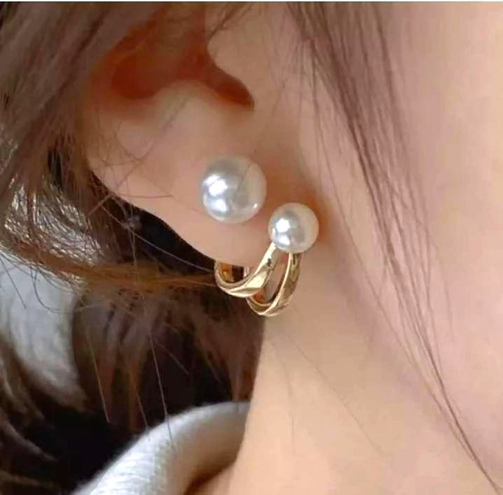 dazzle21 double pearl stud earrings with gold-toned curved metal accents worn on an earlobe