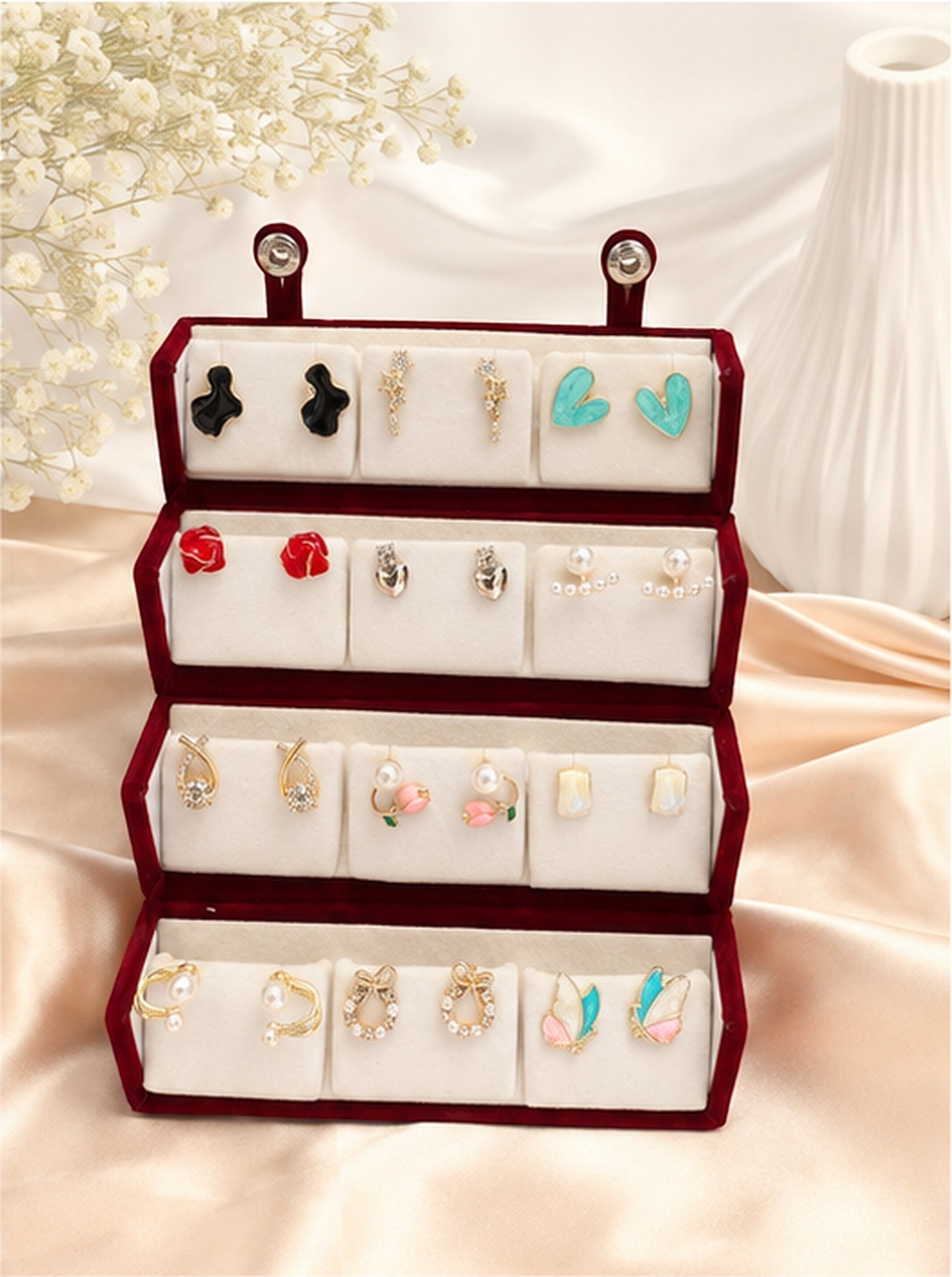 dazzle21 12-pair fashion earring set featuring gold-tone studs, hoops, and pearl accents in a red velvet display box.