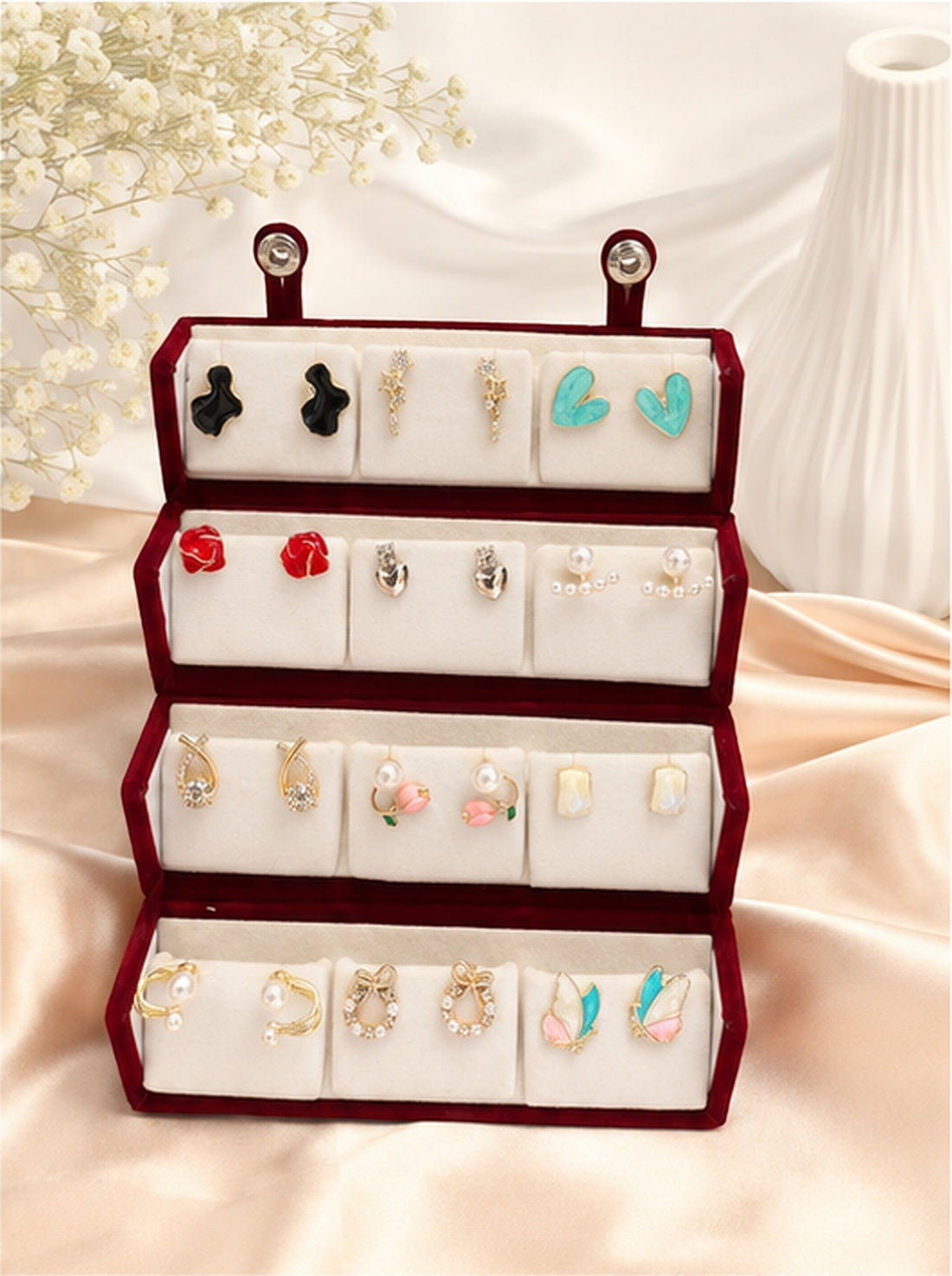 dazzle21 12-pair fashion earring set featuring gold-tone studs, hoops, and pearl accents in a red velvet display box.