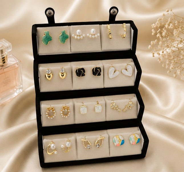 dazzle21 12-pair earring set featuring gold-tone, pearl, and colorful stud and hoop designs in a black display box