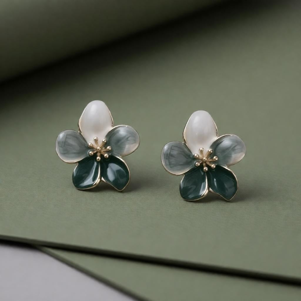 dazzle21 handcrafted floral stud earrings featuring white and deep green enamel petals with delicate gold center details.