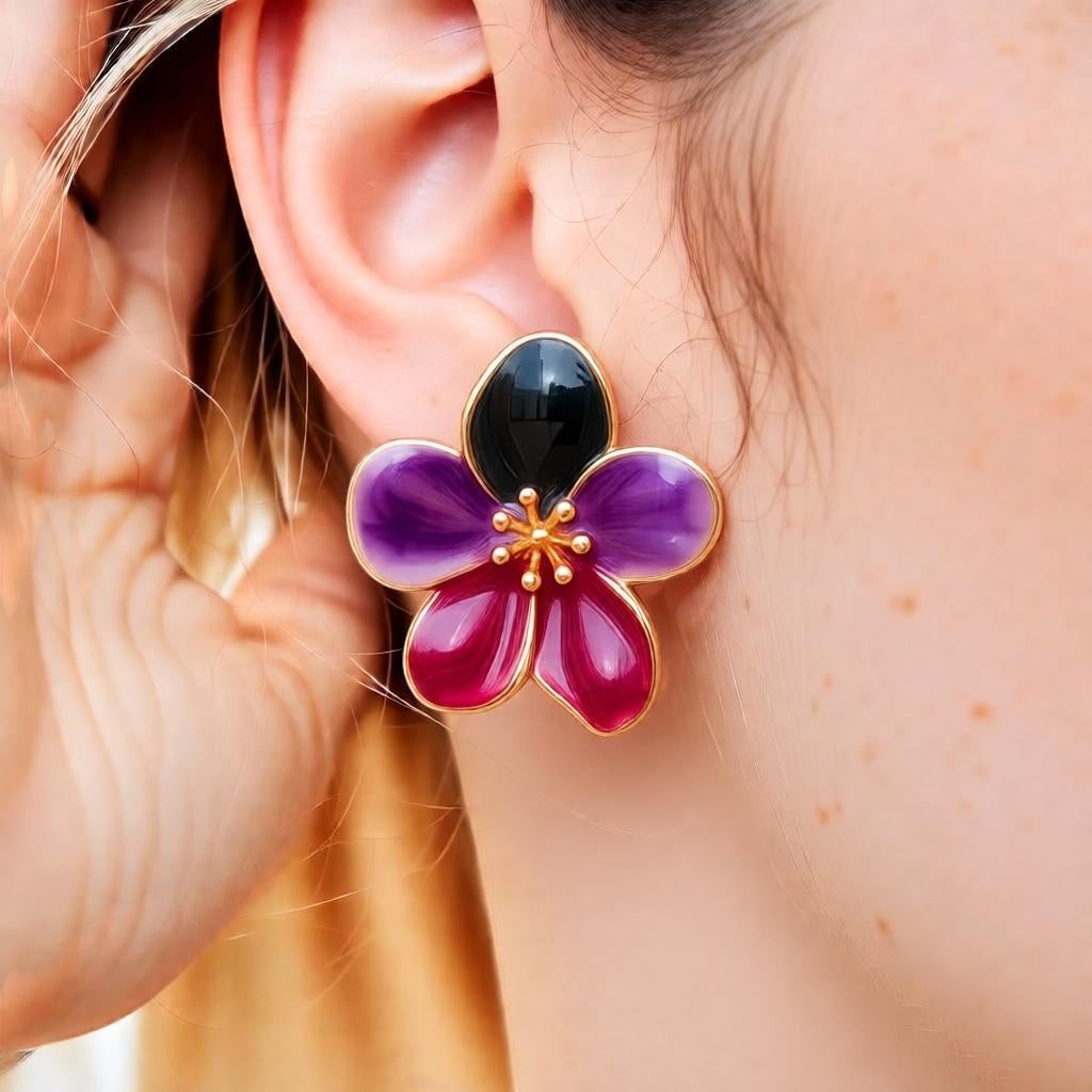 dazzle21 floral stud earrings featuring deep green, purple, and ruby enamel petals with gold center detailing on a model