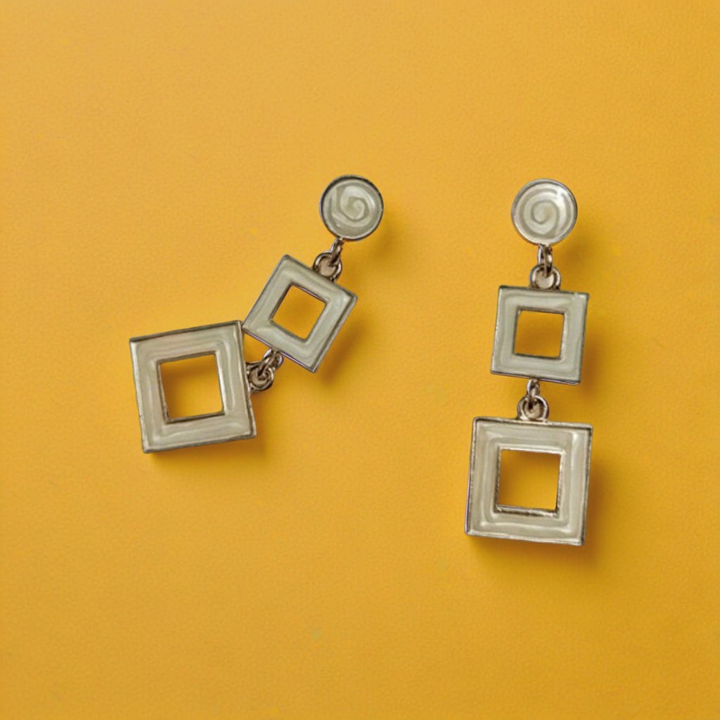 dazzle21 modern geometric square drop earrings in cream with silver-tone metal on a vibrant yellow background
