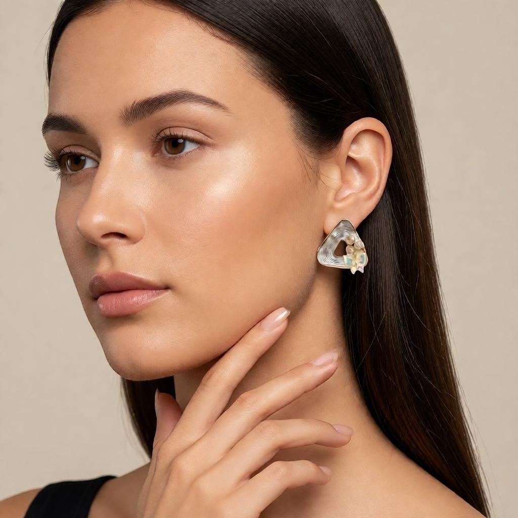 dazzle21 geometric triangle stud earrings with peach pearls and iridescent petal accents on a model