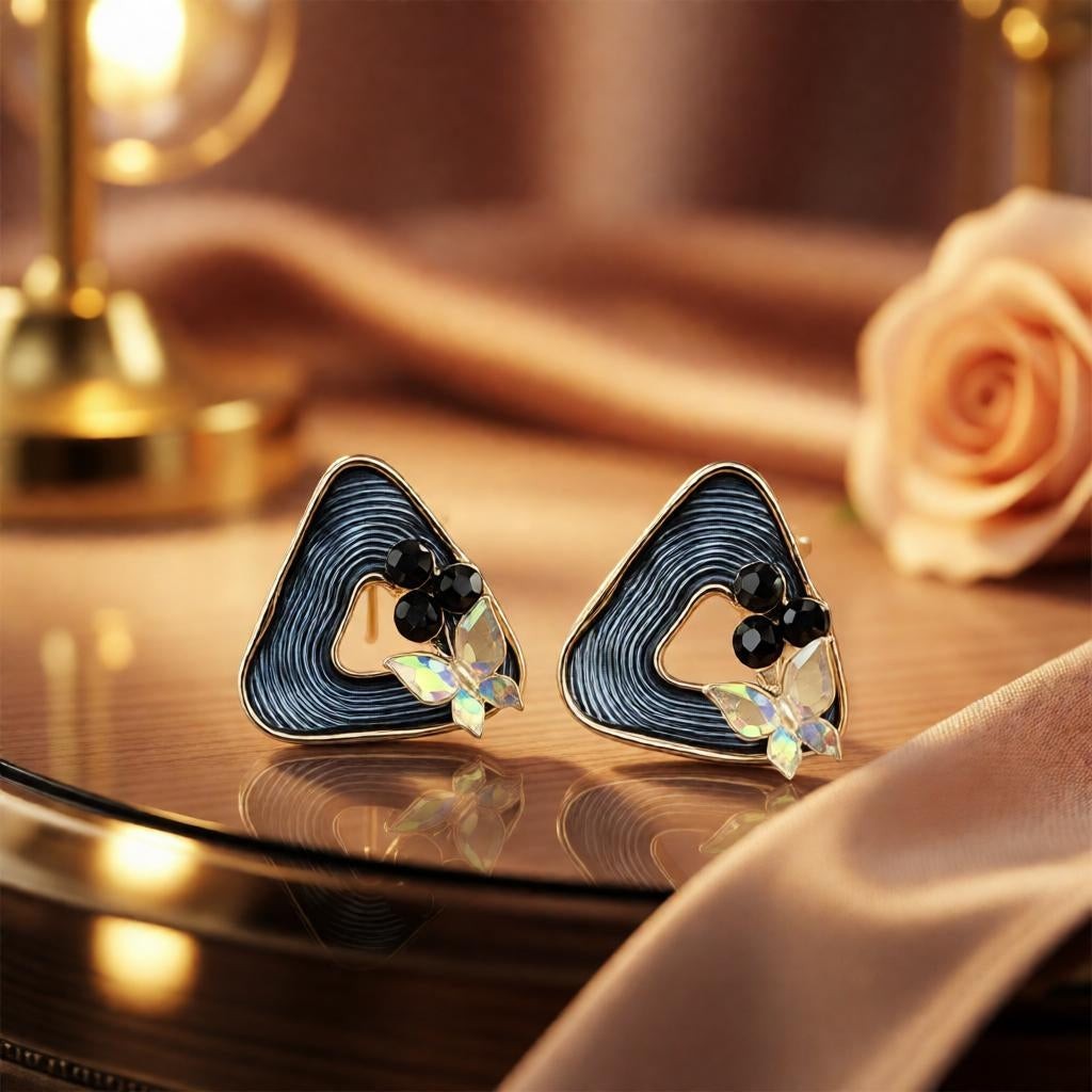 dazzle21 geometric triangle stud earrings with ribbed blue detail, black beads, and iridescent butterfly accents.