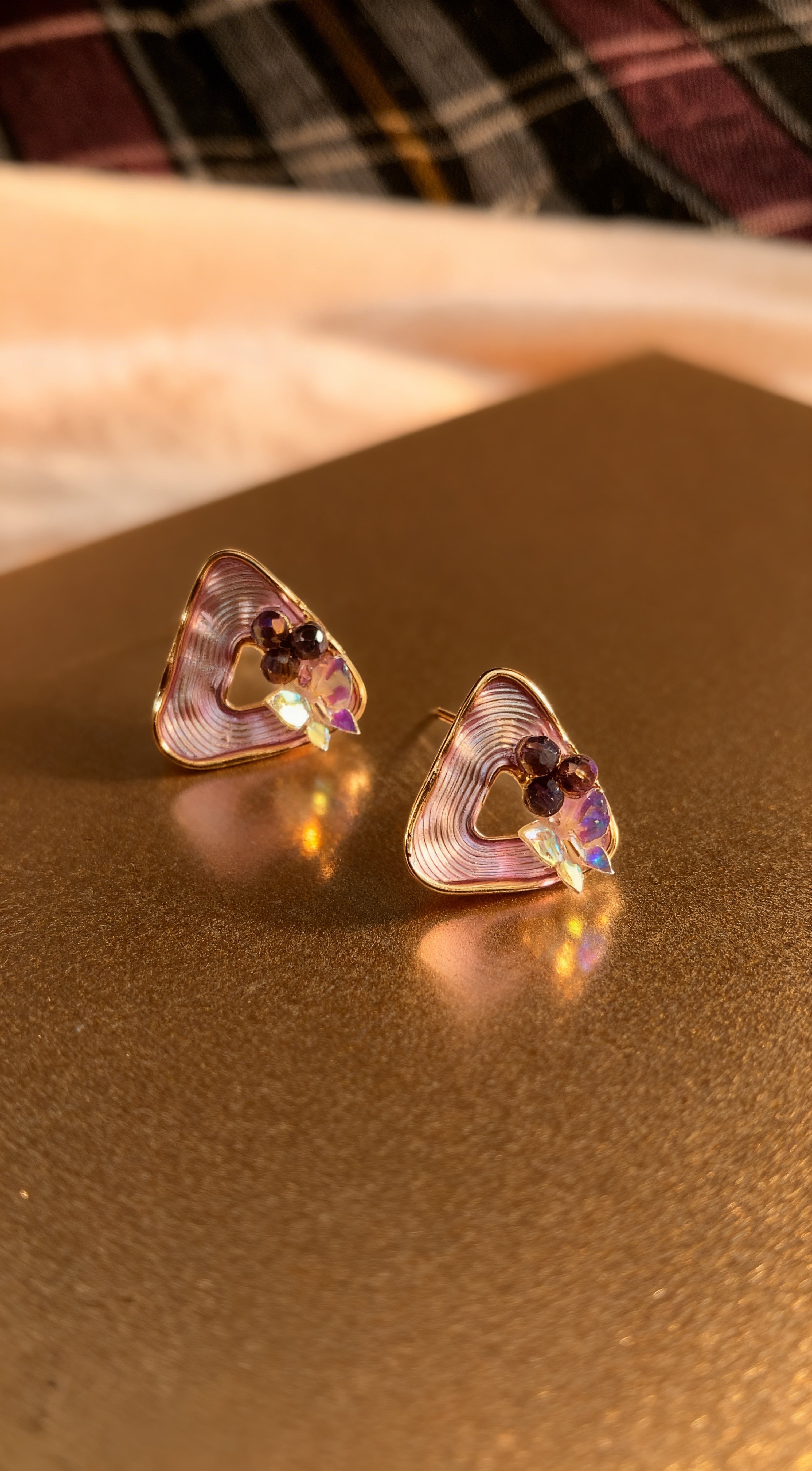 dazzle21 geometric triangle stud earrings with ribbed purple detail, pearl accents, and a high-shine gold finish.