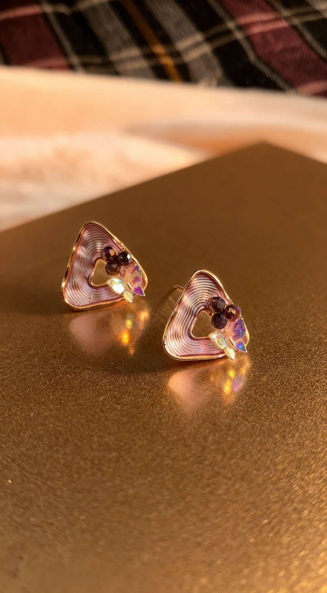 dazzle21 geometric triangle stud earrings with ribbed purple detail, pearl accents, and a high-shine gold finish.