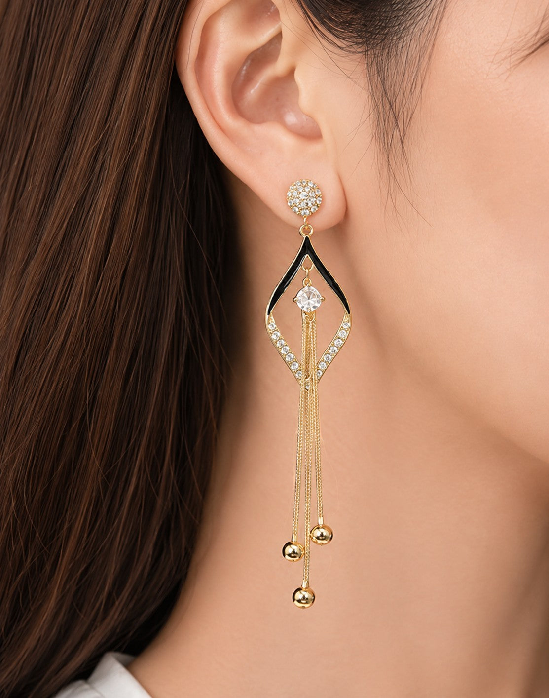 dazzle21 gold-plated drop earrings with black enamel, crystal floral studs, zircon accents, and long tassel chains.