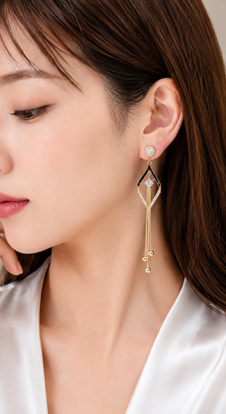 dazzle21 gold-plated long tassel drop earrings with black enamel, zircon accents, and crystal floral studs on a model