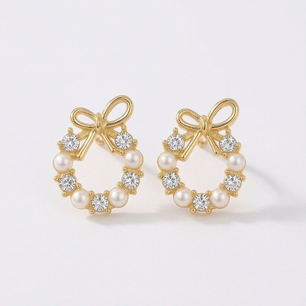 dazzle21 gold-tone bow stud earrings featuring a circular wreath design with alternating white pearls and clear crystals