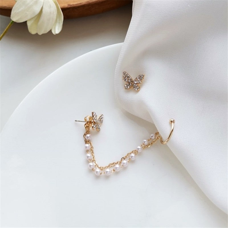 dazzle21 gold butterfly stud earrings with a crystal-embellished chain and white enamel bead ear cuff