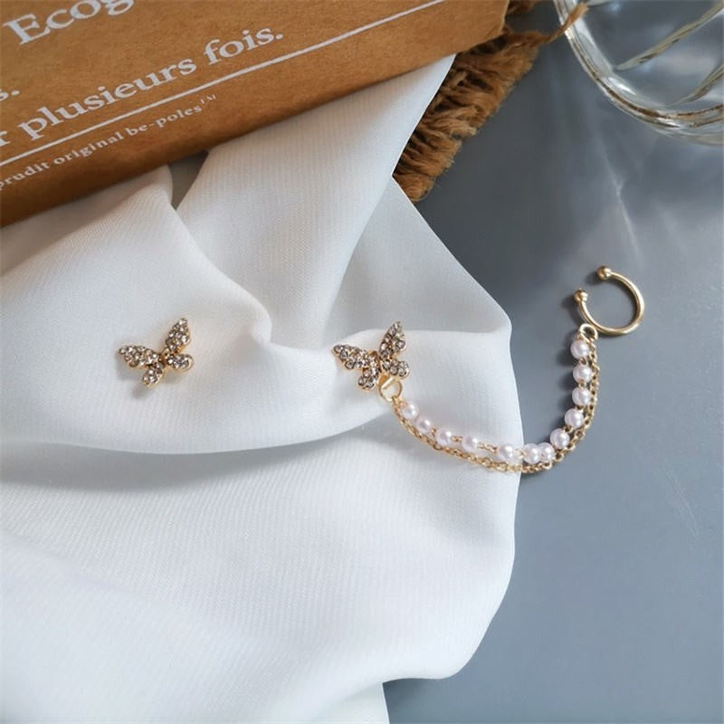 dazzle21 gold butterfly stud earrings with a crystal-embellished chain ear cuff and white enamel bead accents