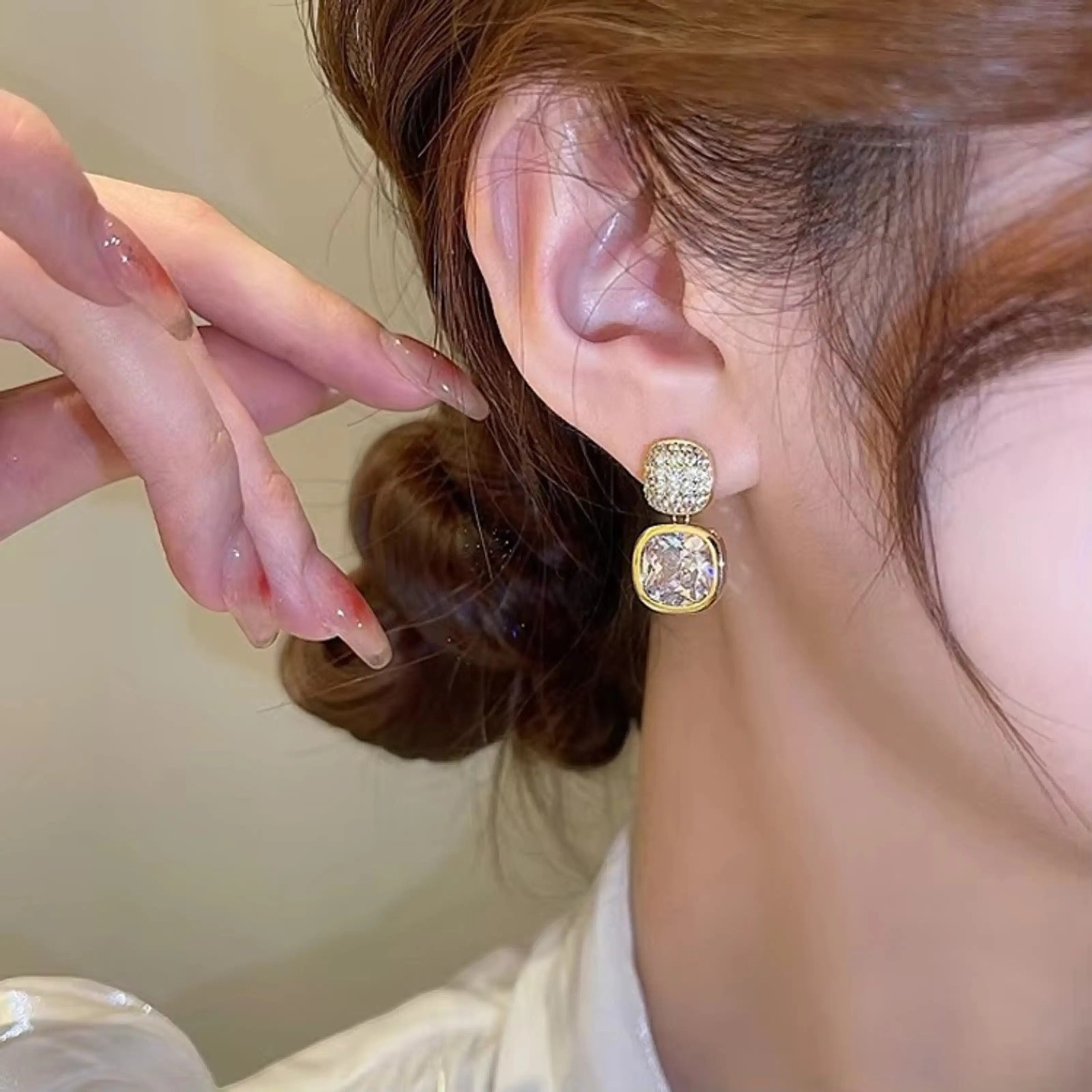 dazzle21 gold-tone drop earrings featuring a square crystal stud and a larger square cubic zirconia pendant