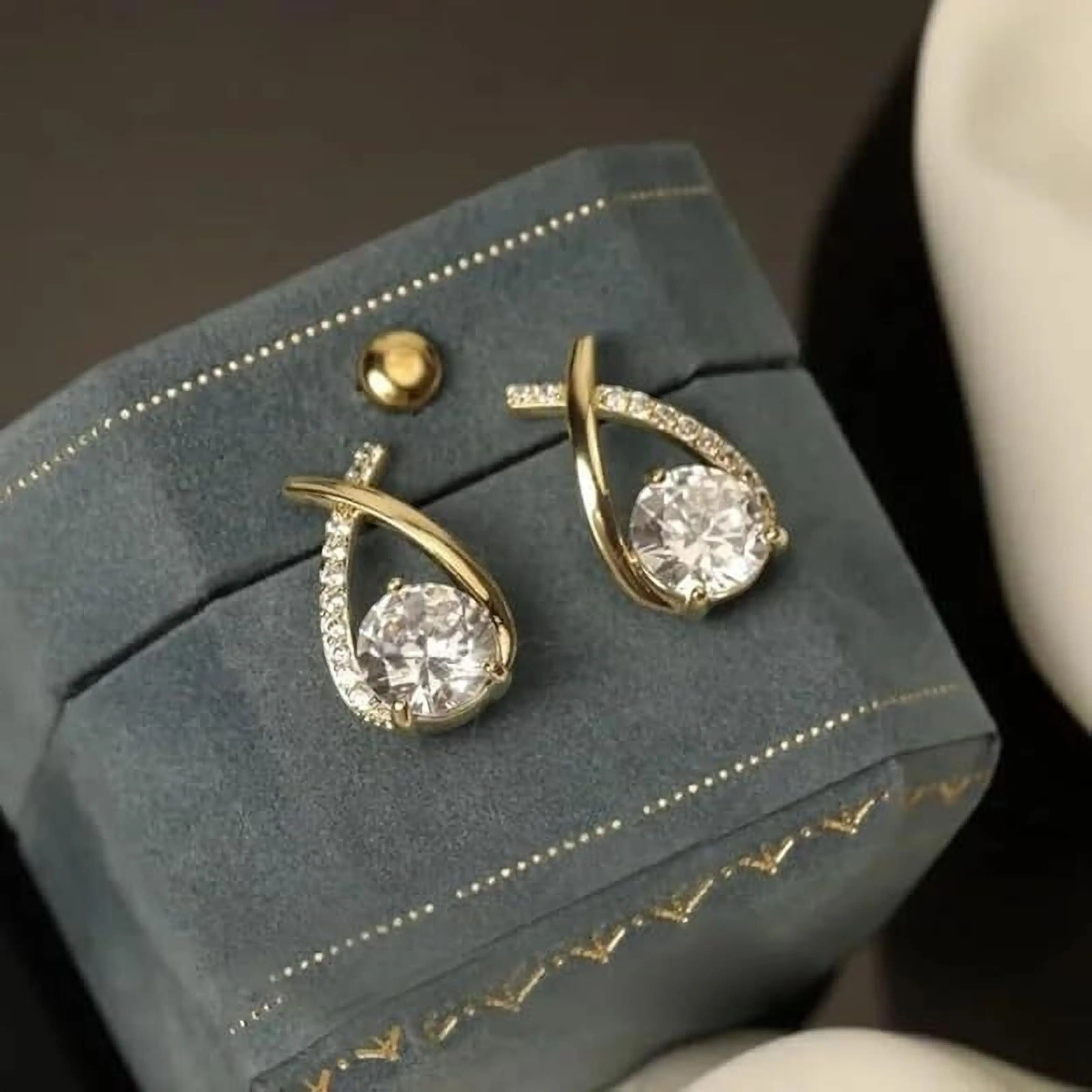 dazzle21 gold-tone crossover drop earrings featuring a central round crystal and pavé rhinestone accents