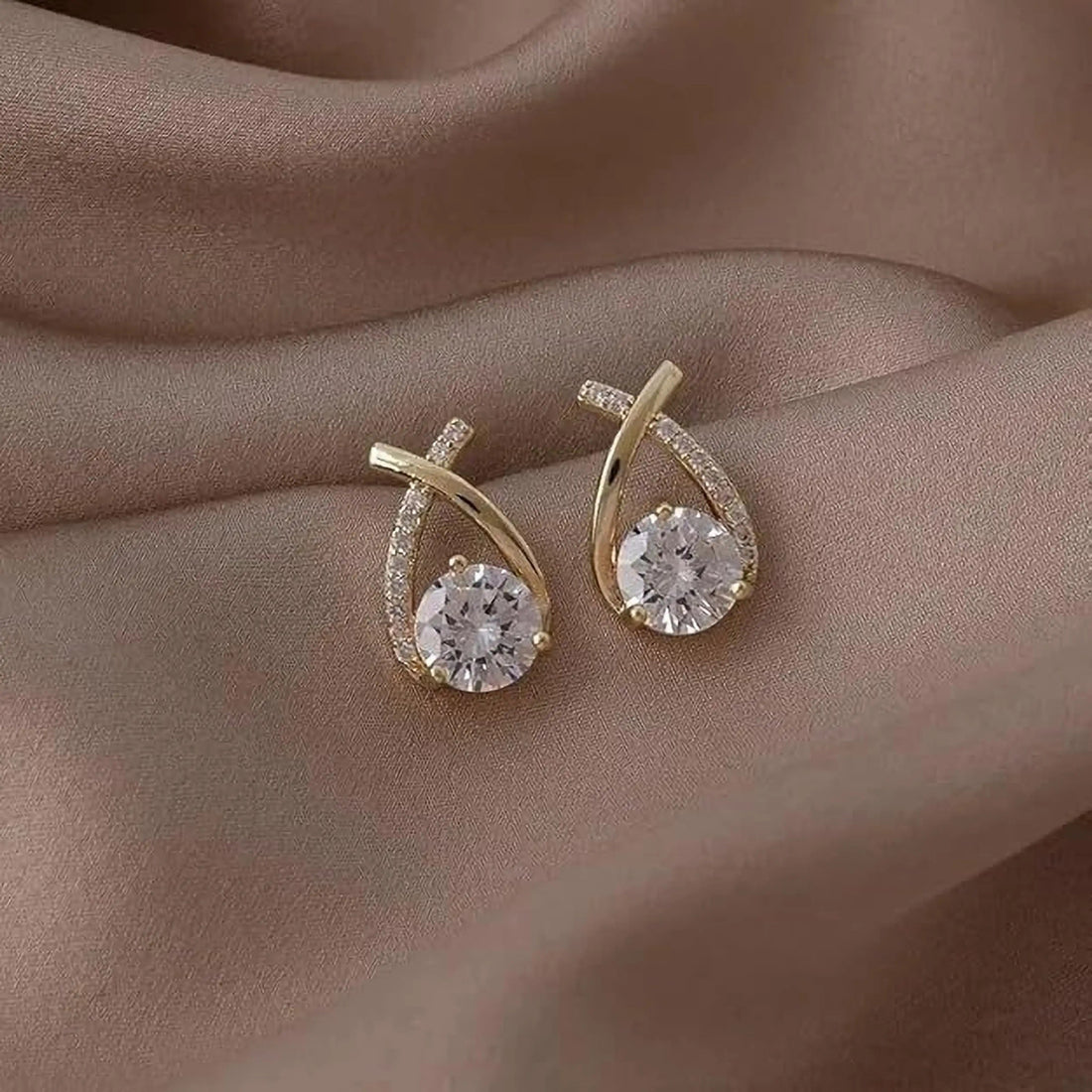 dazzle21 gold-tone alloy stud earrings featuring a teardrop-shaped frame with clear crystal rhinestones