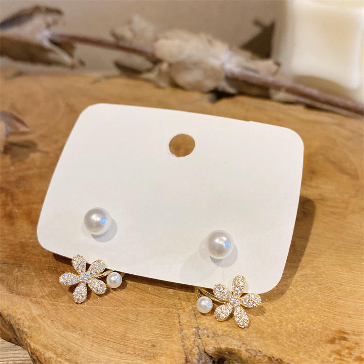 dazzle21 gold daisy ear jacket earrings with micro-crystals and lustrous faux pearls on a white display card