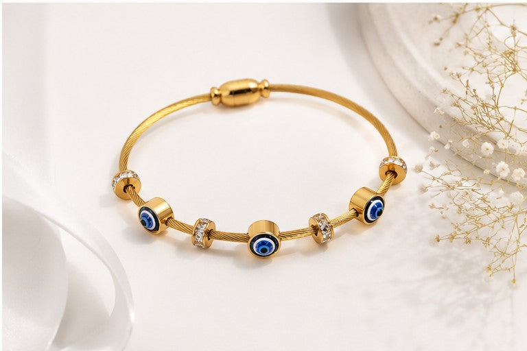 dazzle21 gold-tone wire bracelet featuring three blue evil eye nazar charms and crystal-accented spacers