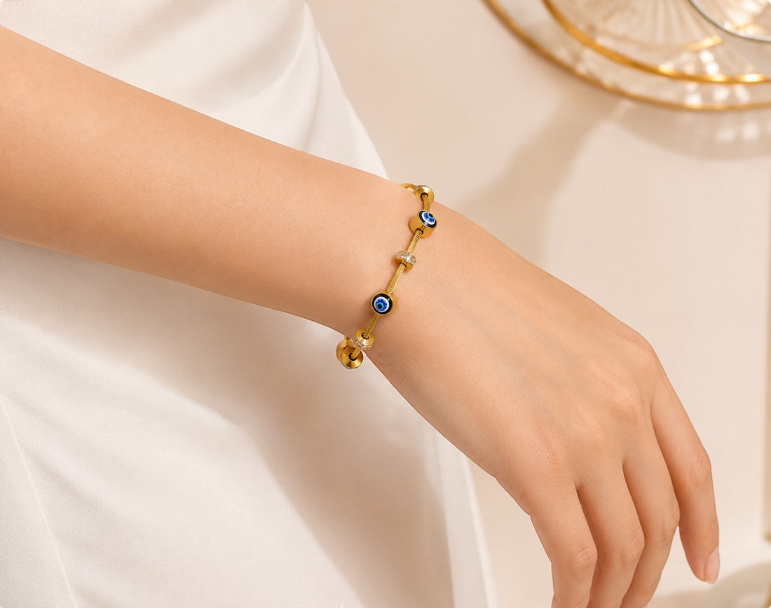 dazzle21 gold-tone bracelet featuring blue evil eye nazar charms and small crystal accents on a woman's wrist