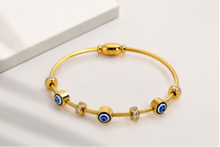 dazzle21 gold-tone cable wire bracelet featuring blue evil eye nazar charms and sparkling crystal accent beads