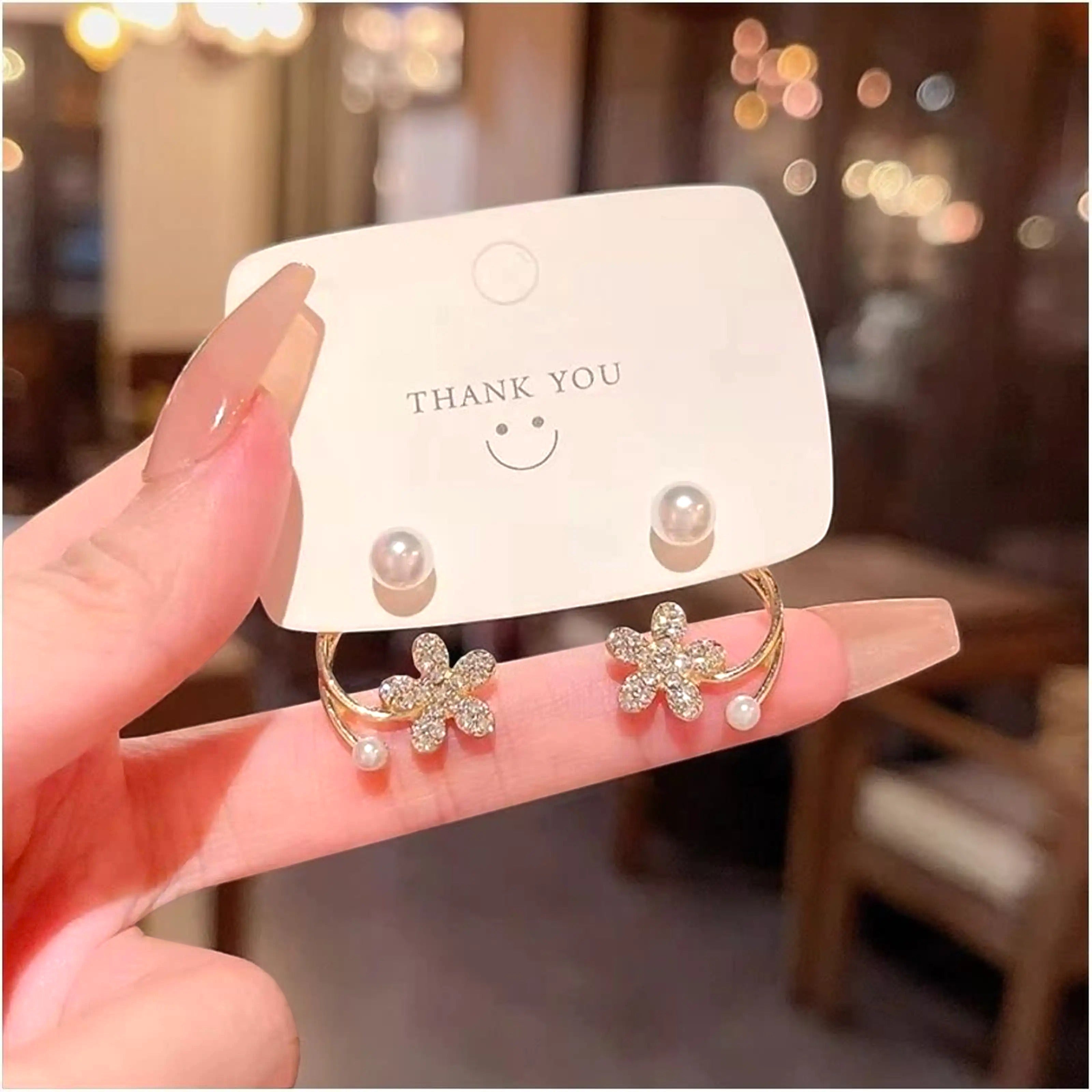 dazzle21 gold flower earrings with crystal rhinestones and small pearls on a thank you display card