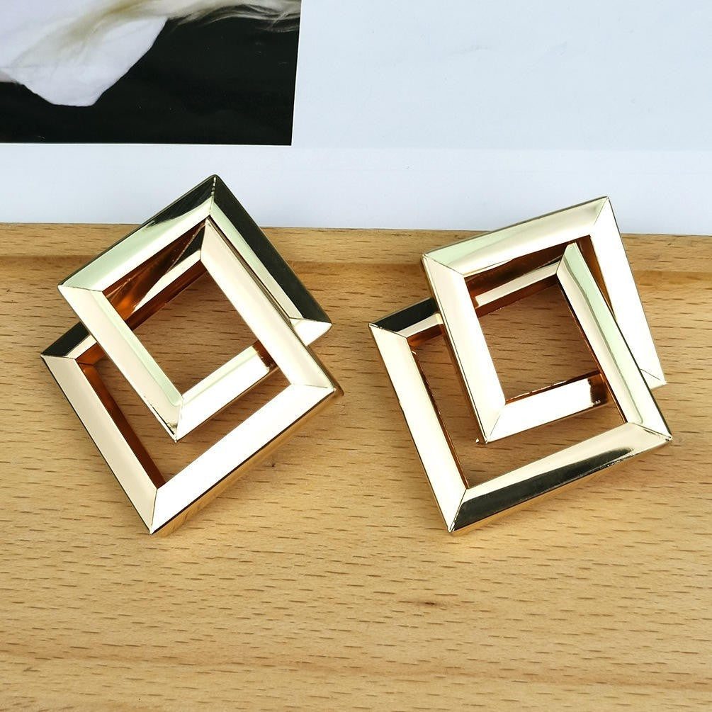 dazzle21 geometric square statement earrings featuring a polished gold-tone finish and layered open-frame design.