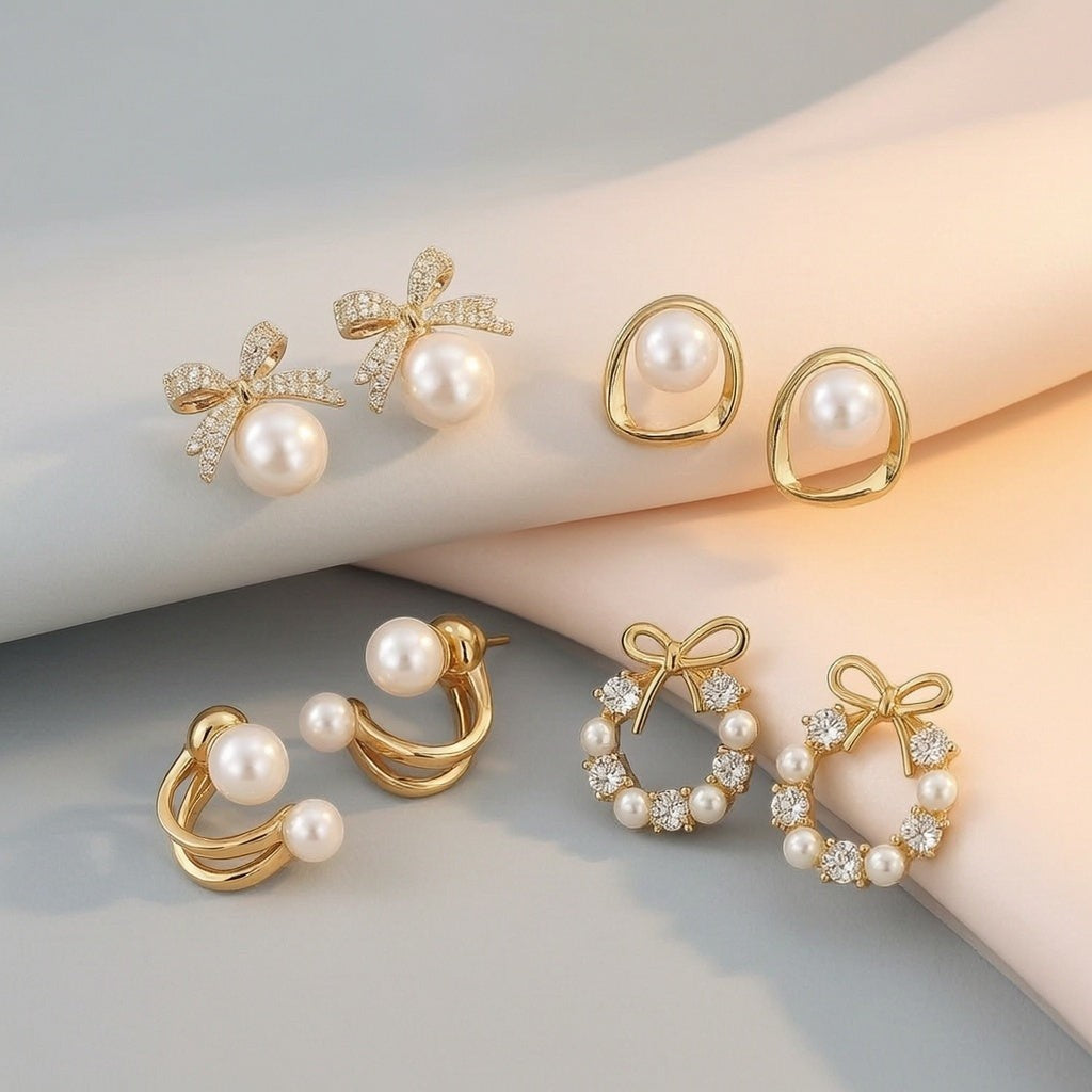 dazzle21 set of four gold-tone stud earrings featuring pearl bows, minimalist hoops, and rhinestone wreath designs.