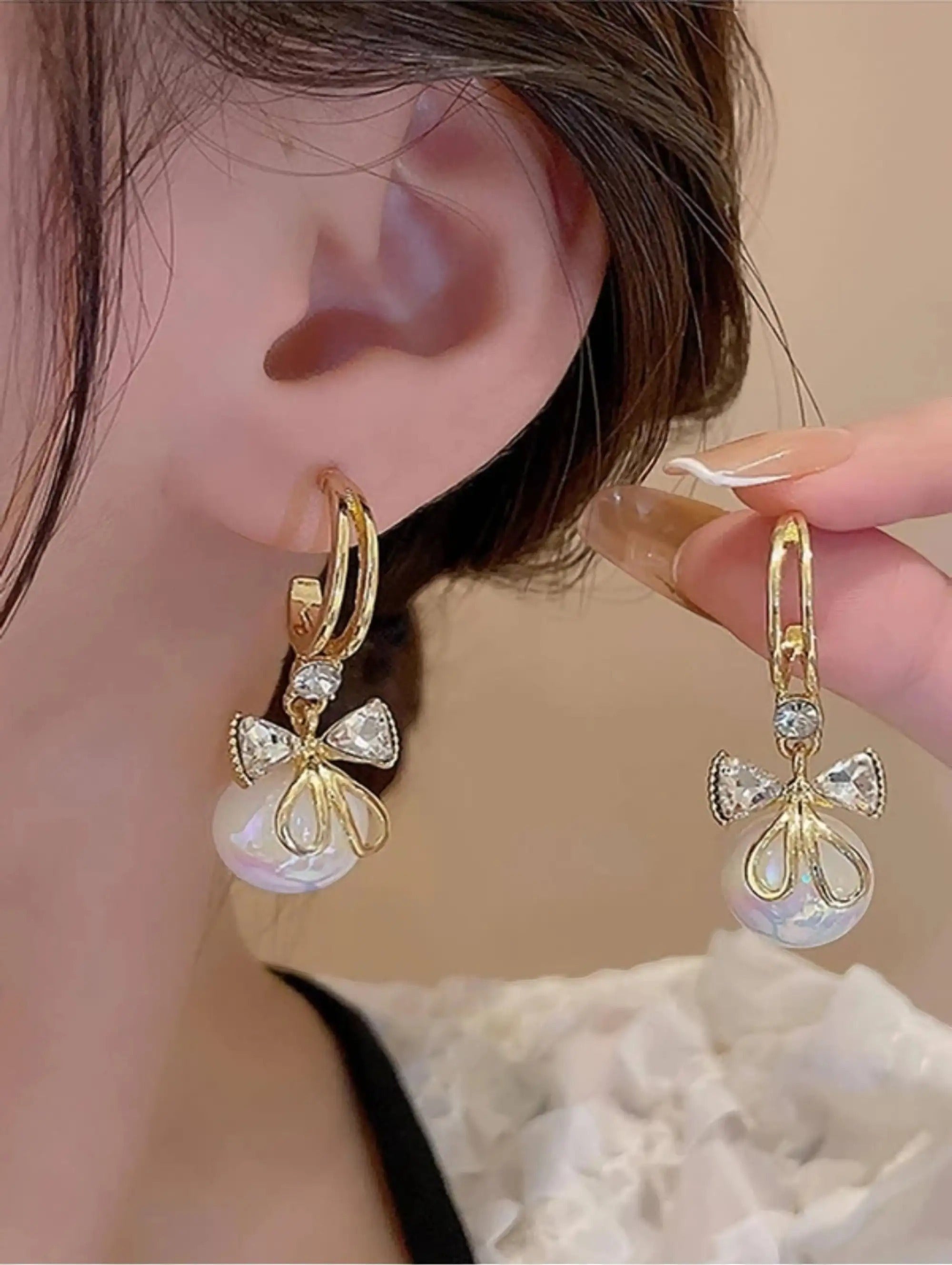 dazzle21 gold-tone alloy hoop earrings featuring a crystal bow and iridescent pearl drop for women
