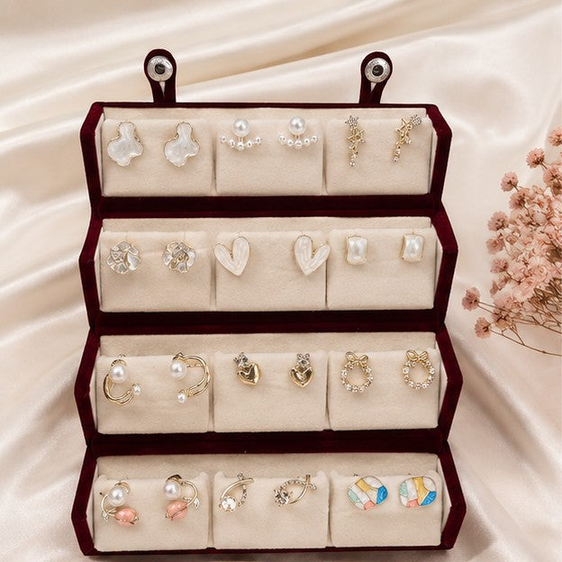 dazzle21 12-pair earring set featuring gold-tone studs, hoops, and pearl accents in a velvet display box