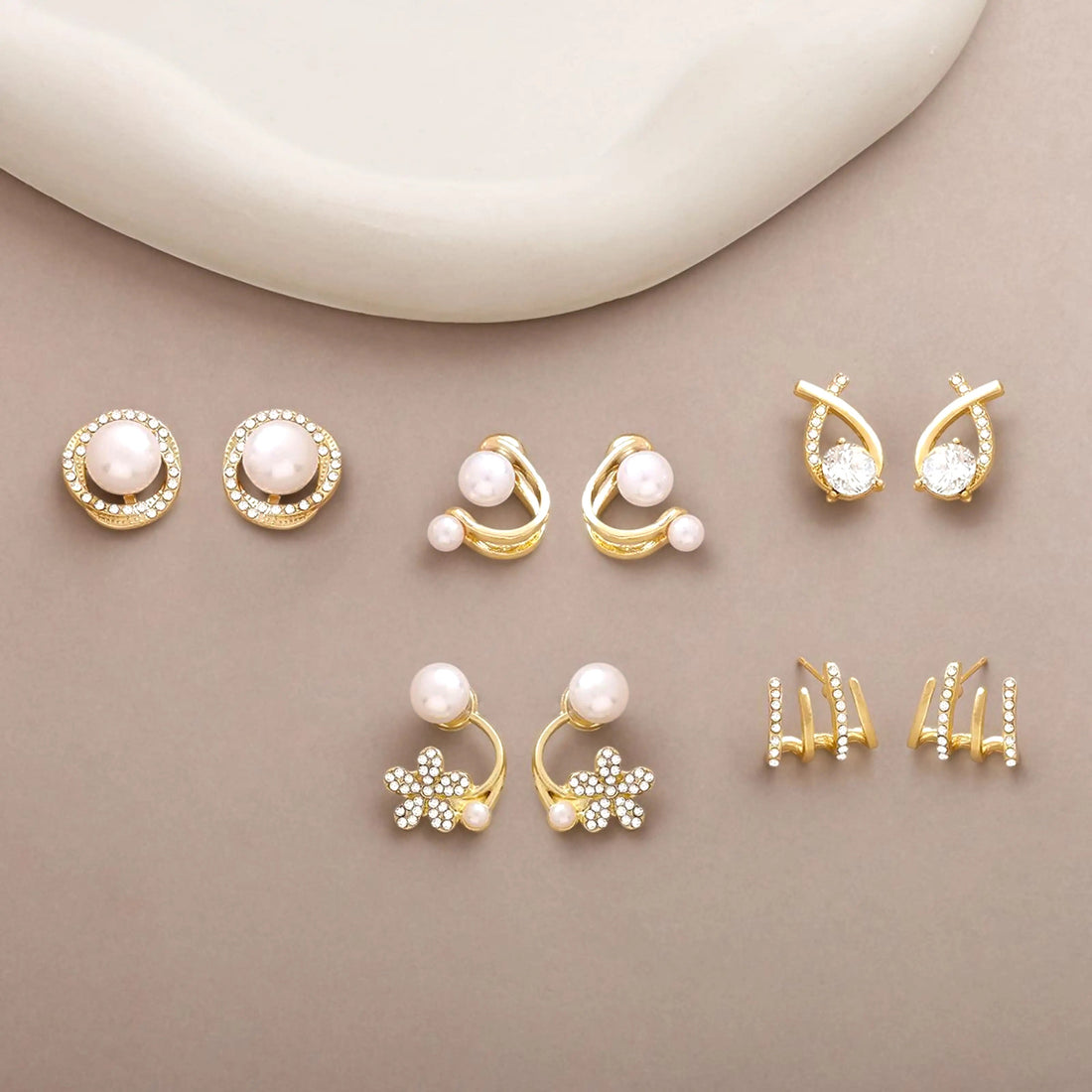 dazzle21 gold-tone alloy stud earring set featuring faux pearls, zirconia crystals, star, and leaf motifs
