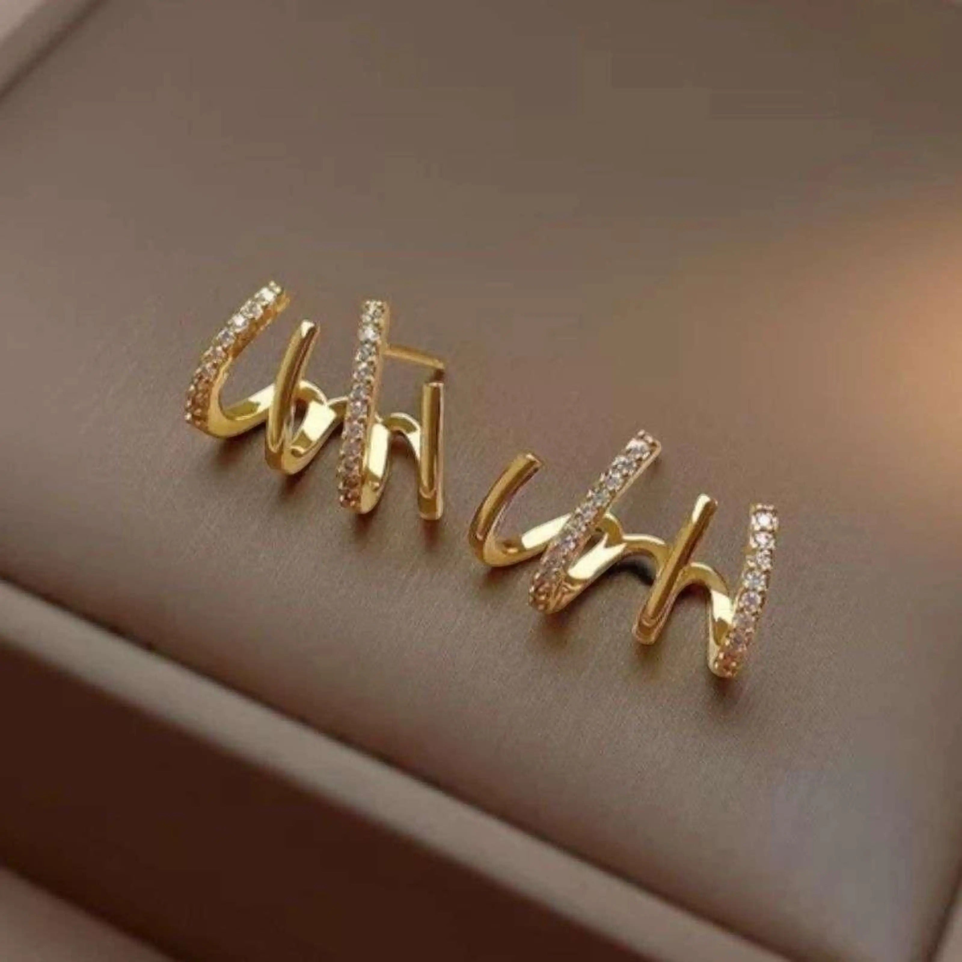 dazzle21 gold-tone alloy stud earrings featuring a modern triple-loop design with sparkling crystal accents