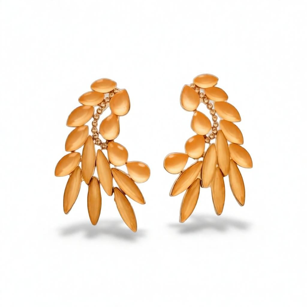 dazzle21 golden leaf-shaped statement stud earrings with crystal accents for festive and wedding wear.