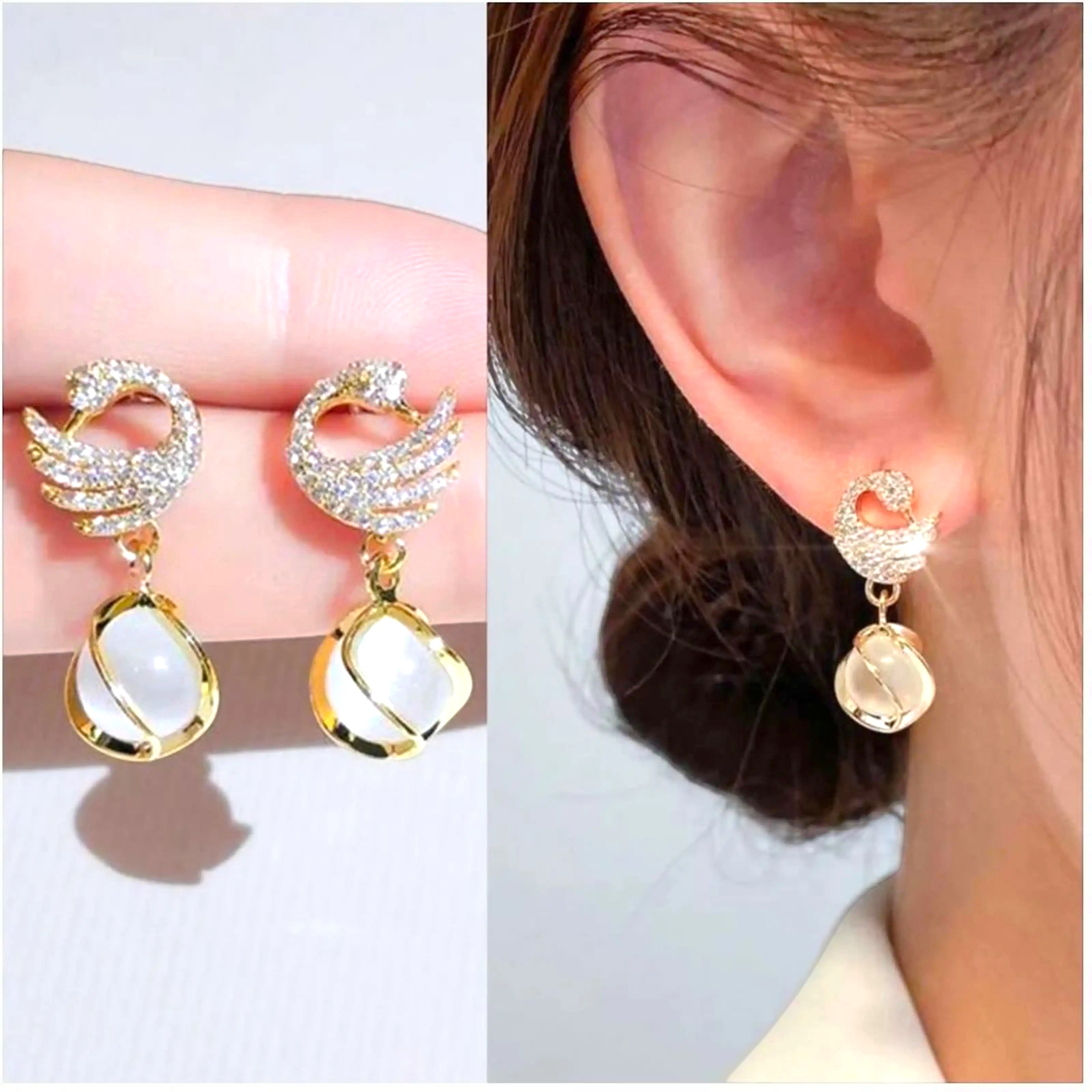 dazzle21 golden swan-shaped earrings with sparkling cubic zirconia and white stone drops worn on an ear
