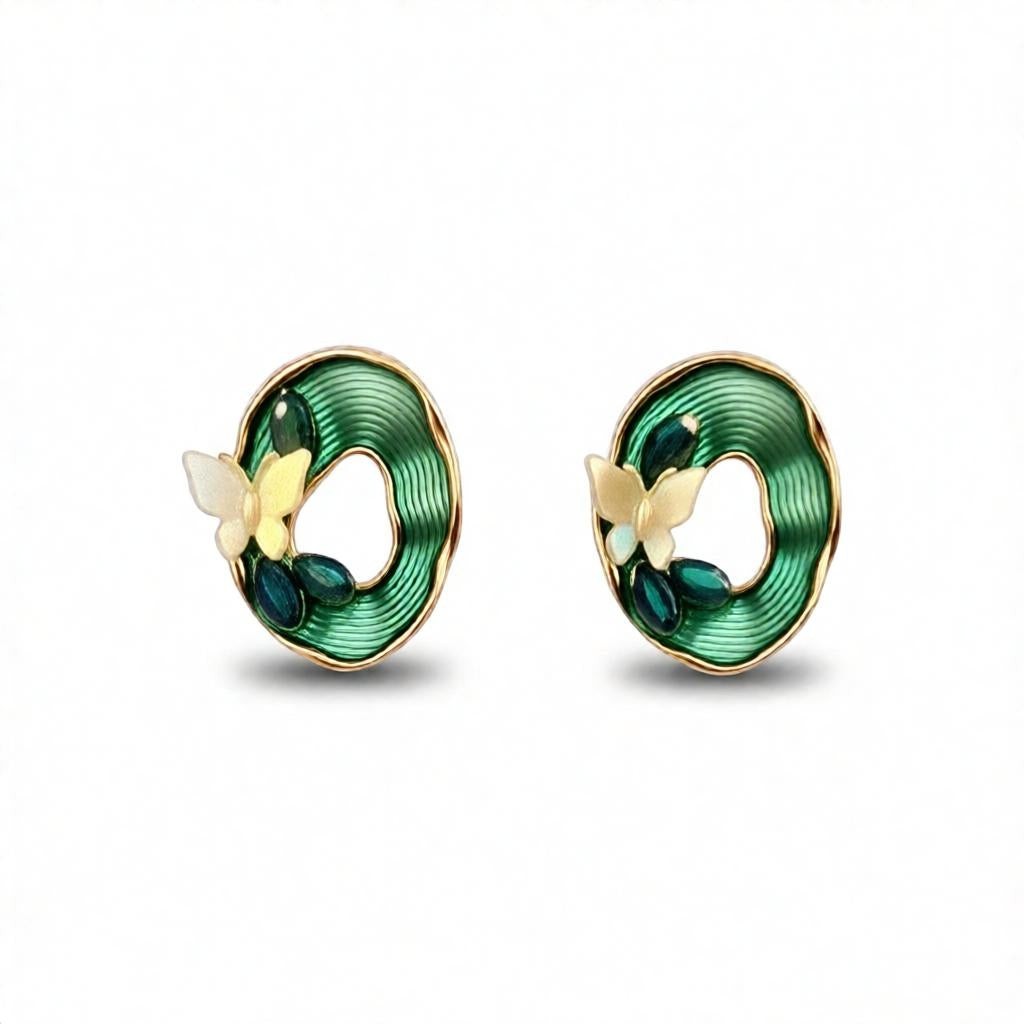 dazzle21 oval stud earrings featuring green textured enamel, gold butterfly accents, and dark green stone details.