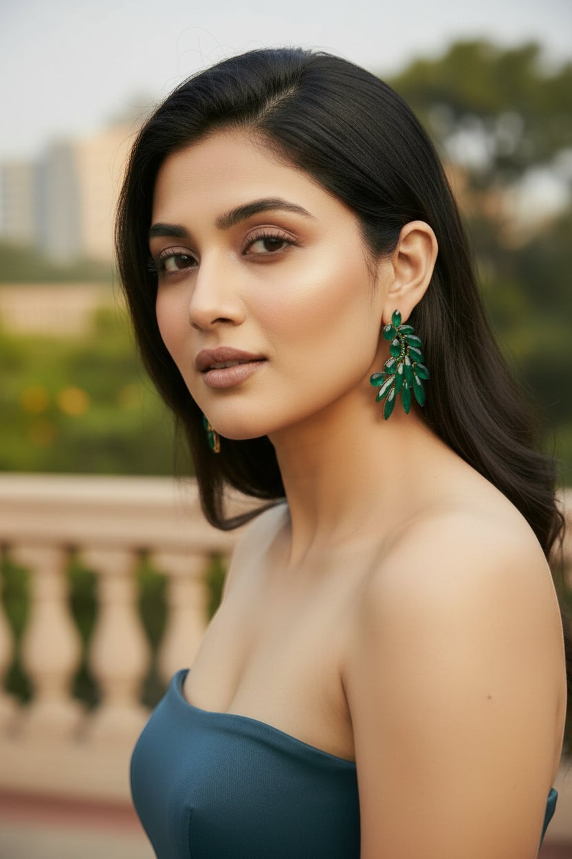 dazzle21 green leaf-shaped crystal stud earrings worn by a woman, featuring a golden-tone finish for elegant style.