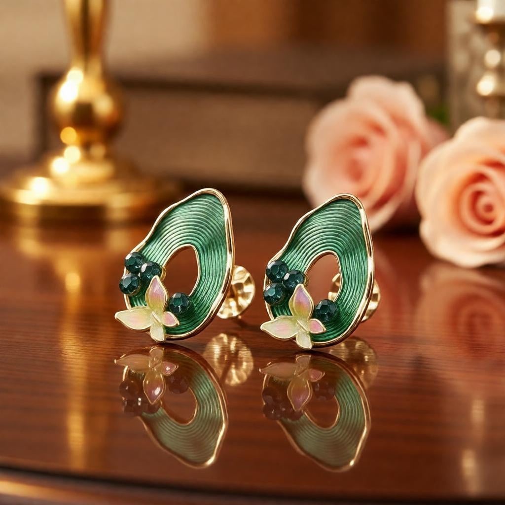 dazzle21 pear-shaped ribbed green teardrop earrings with butterfly and pearl accents on a wooden table