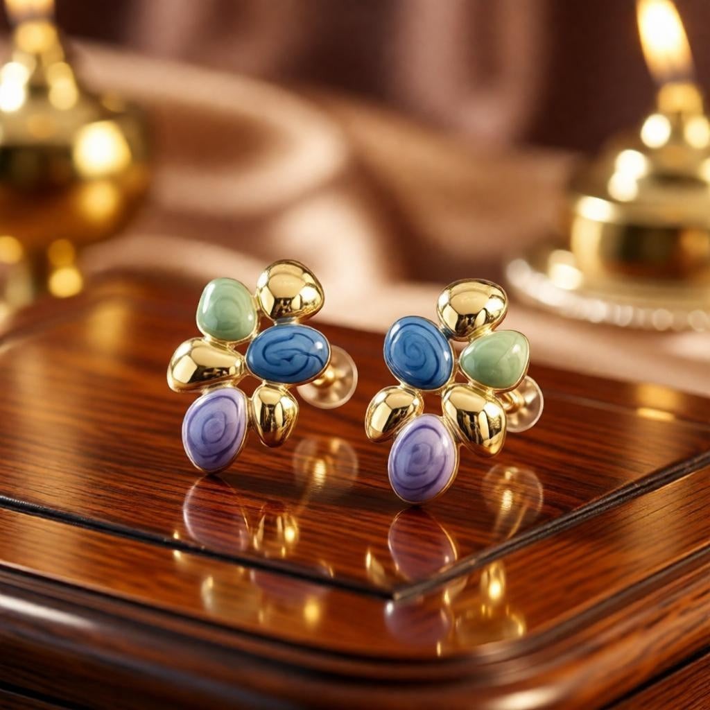 dazzle21 modern stud earrings featuring pastel marbled enamel pebbles and gold accents on a polished wooden surface
