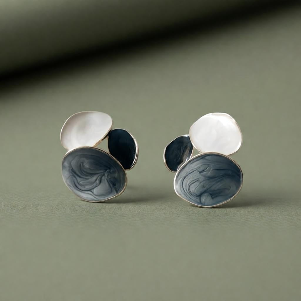dazzle21 handcrafted pastel statement earrings with blue and white marble resin swirls on a green background