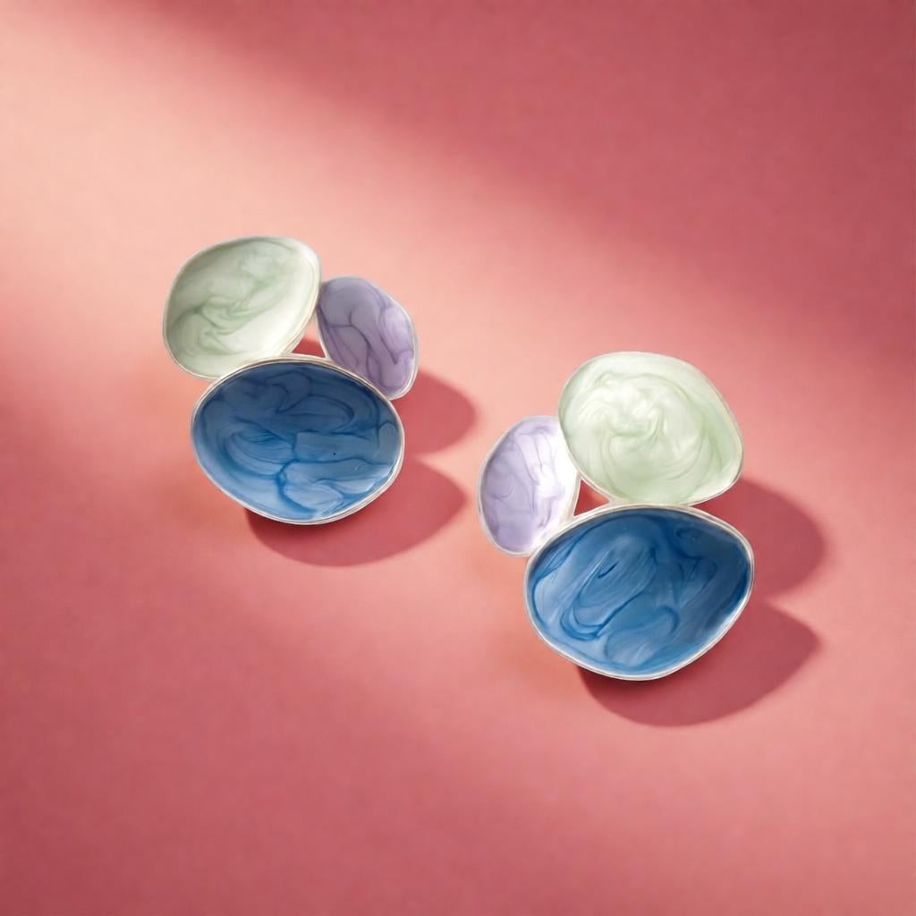 dazzle21 handcrafted resin statement earrings with blue, mint green, and lavender marble swirls on a pink background