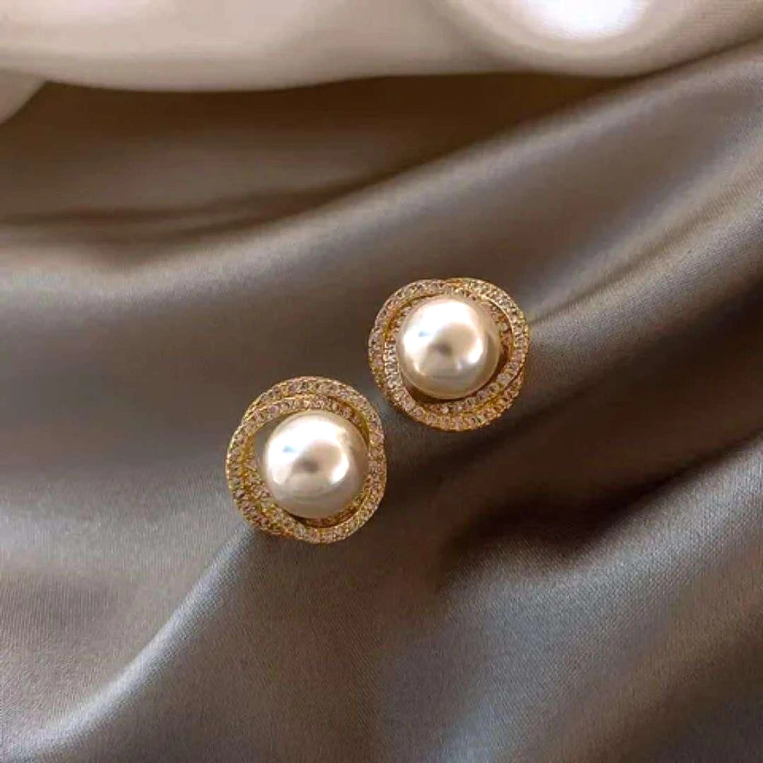 dazzle21 gold-tone stud earrings featuring a central white pearl surrounded by a halo of sparkling zirconia crystals