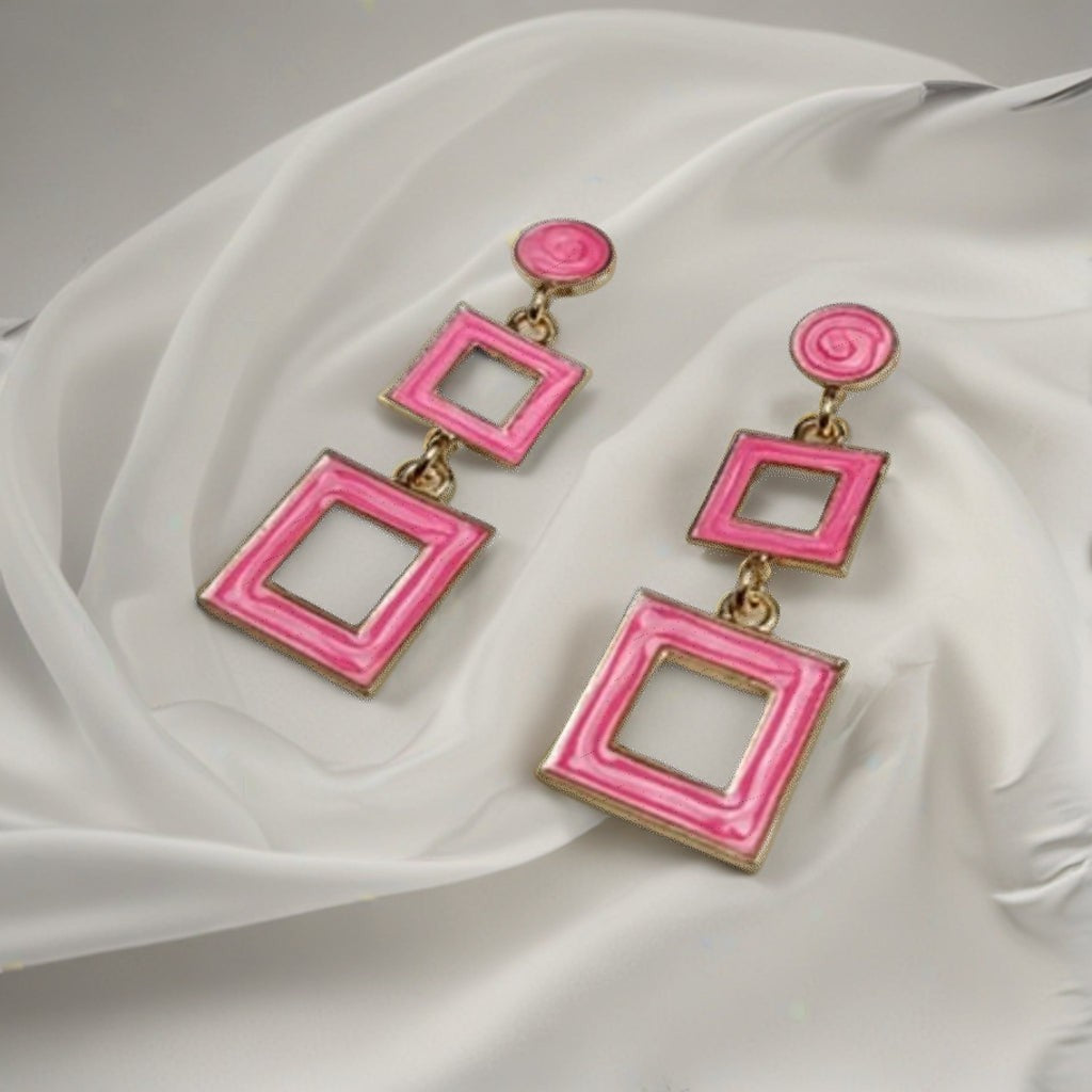 dazzle21 pink geometric square drop earrings with a modern double-square design on a soft white fabric background