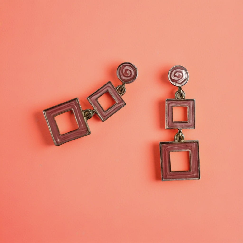 dazzle21 geometric square drop earrings in dusty pink with a modern double-square design on a coral background