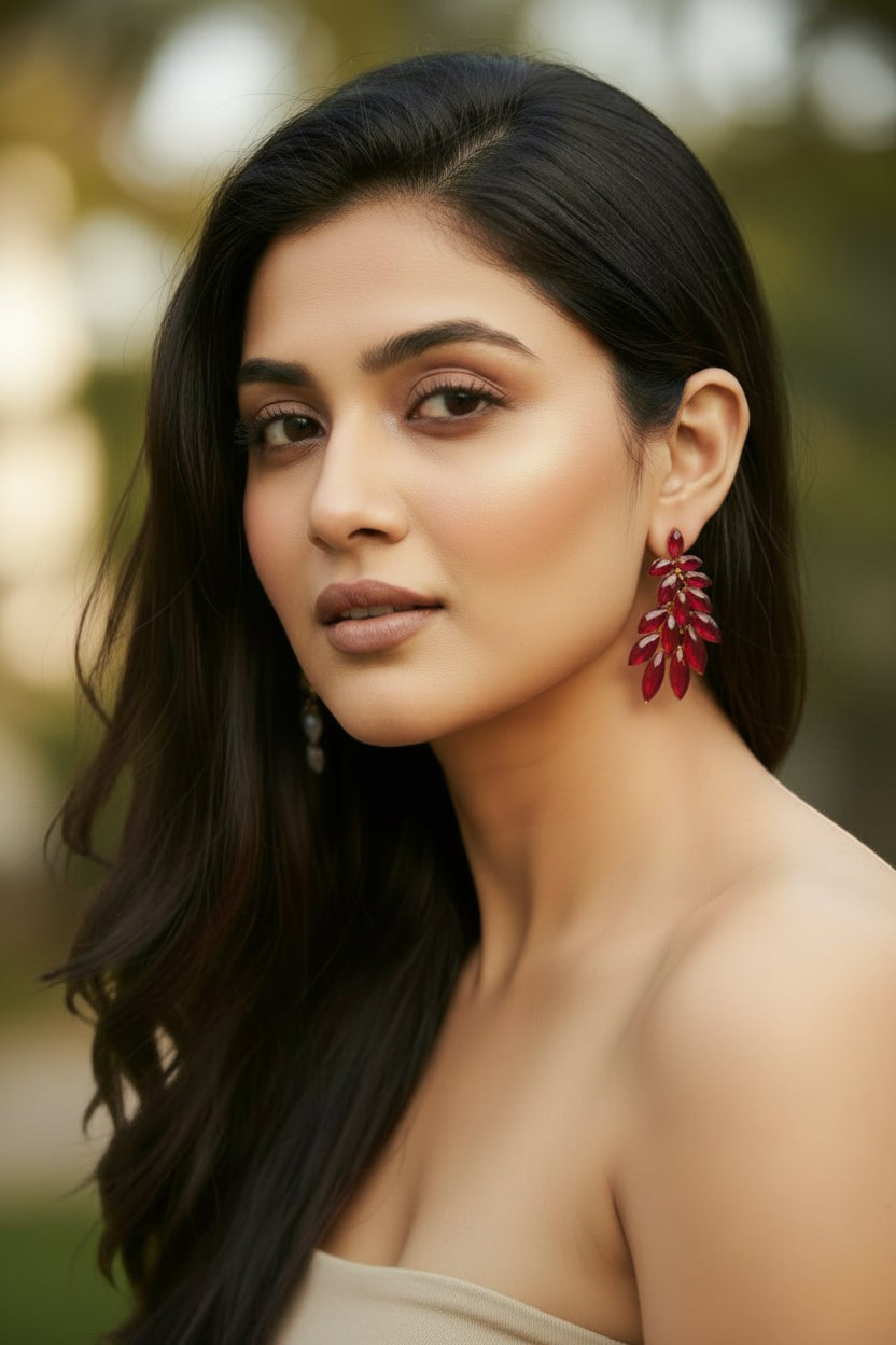 dazzle21 elegant red crystal leaf-shaped statement stud earrings worn by a woman with long dark hair