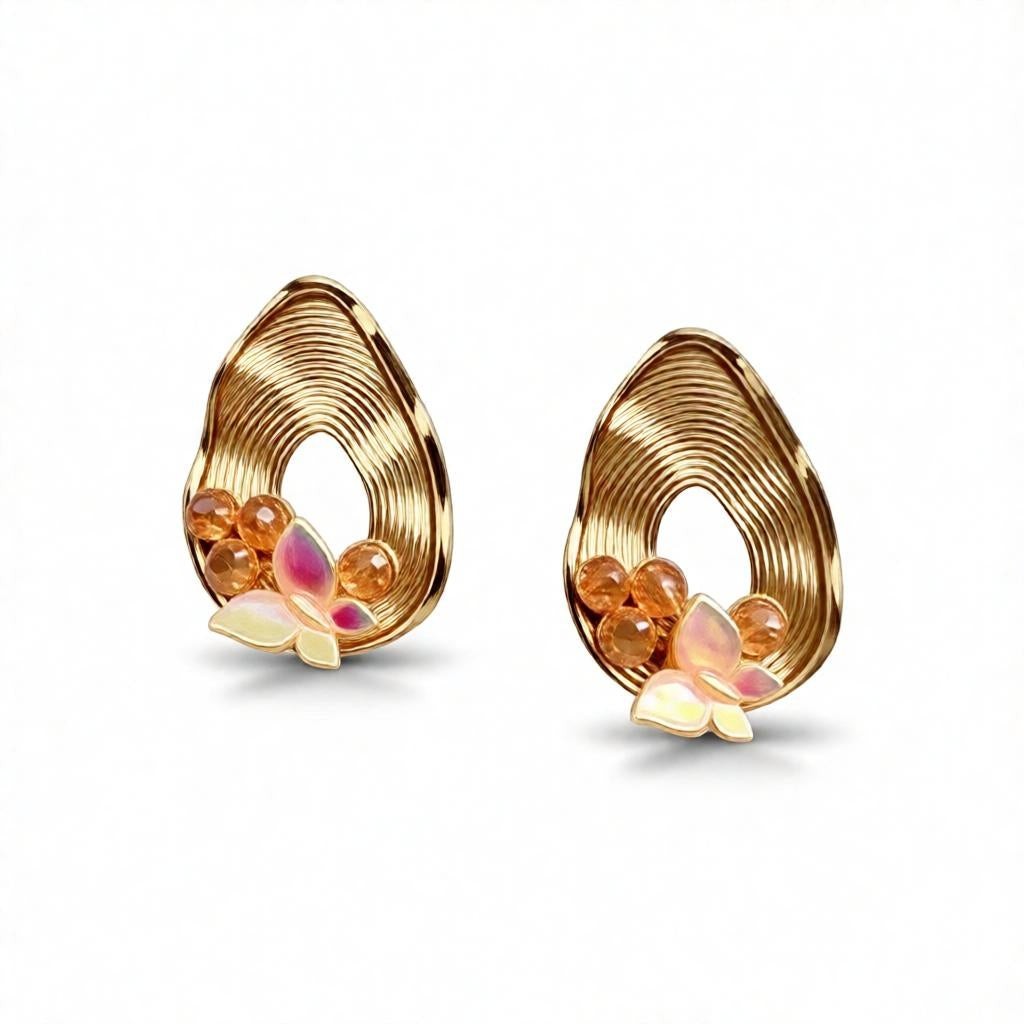 dazzle21 pear-shaped ribbed gold earrings with butterfly accents, opalescent stones, and pearl detailing.