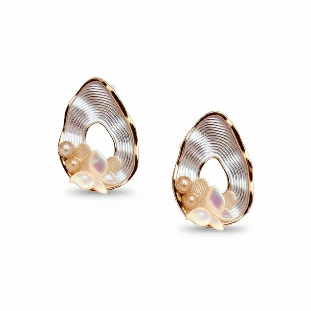 dazzle21 pear-shaped teardrop earrings featuring ribbed gold frames, opalescent butterfly accents, and pearl details.