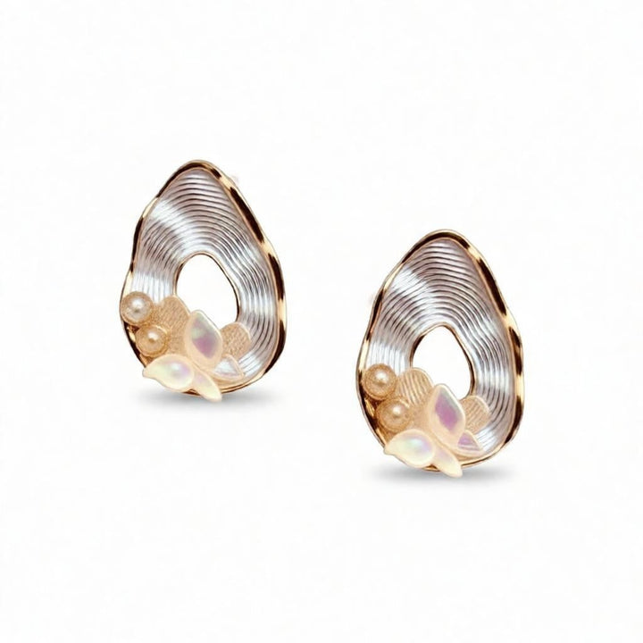 dazzle21 pear-shaped teardrop earrings featuring ribbed gold frames, opalescent butterfly accents, and pearl details.