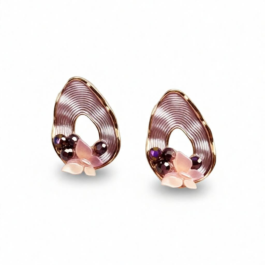 dazzle21 pear-shaped ribbed gold earrings with butterfly accents, pearl detailing, and dark crystal embellishments.